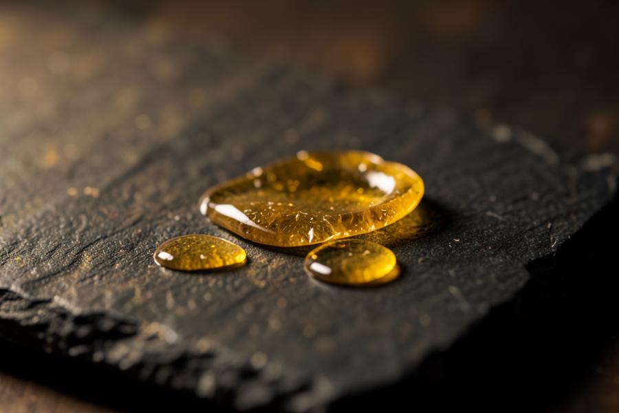 Golden boswellia resin tears resting on dark stone