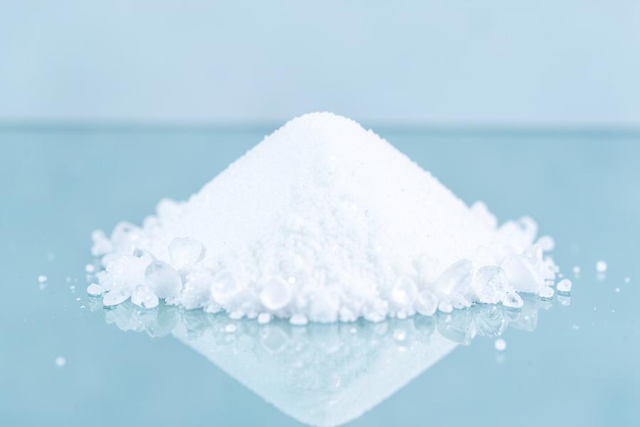 White crystalline MSM powder on a glass surface